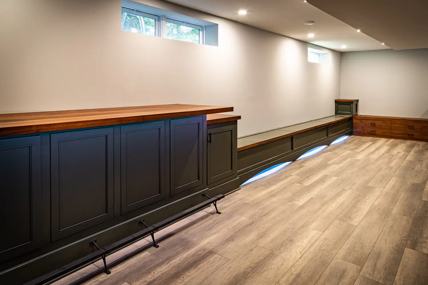 Lower level bar with panelled wainscot and a wood counter