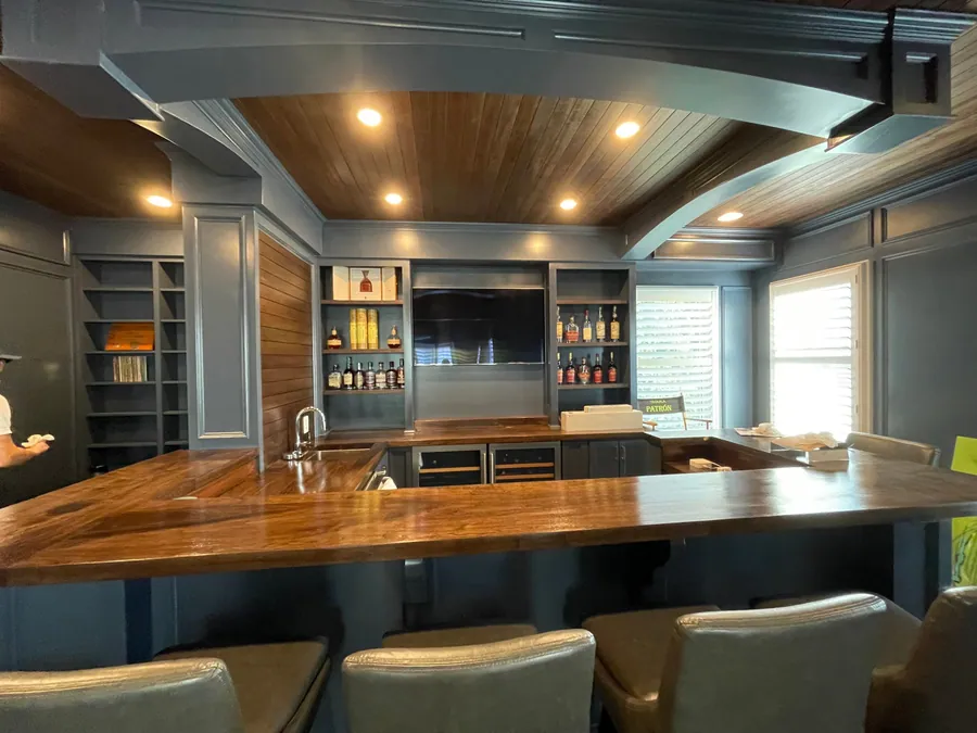 Finished lower level with a bar and wood ceiling