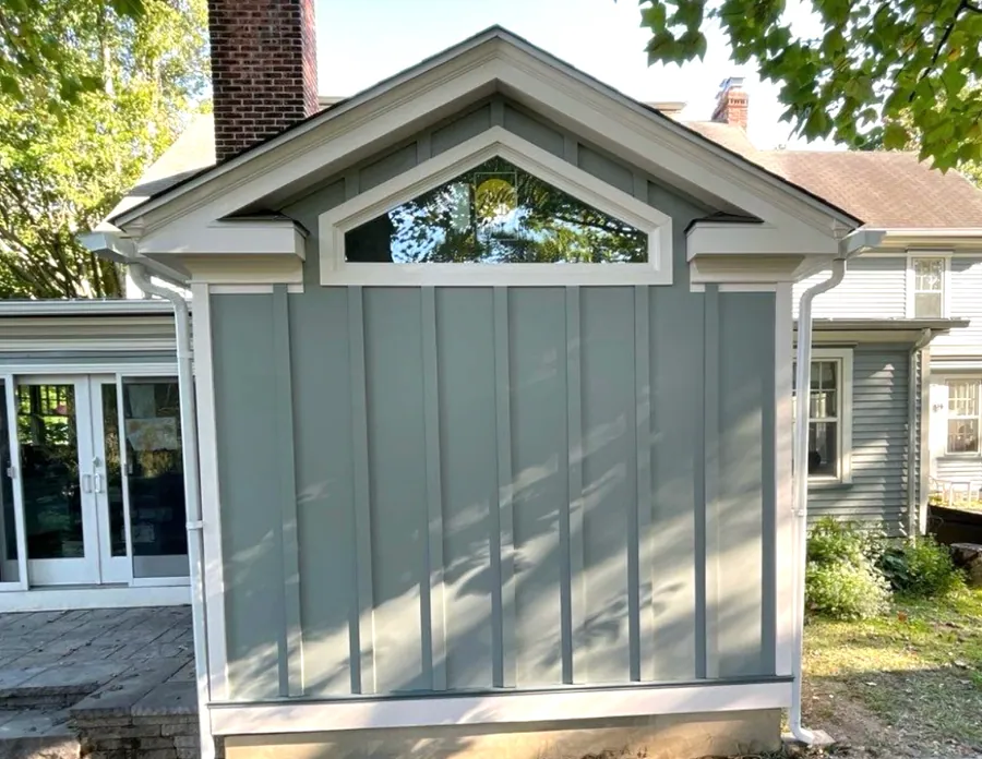 Board and batten shed with a gable window