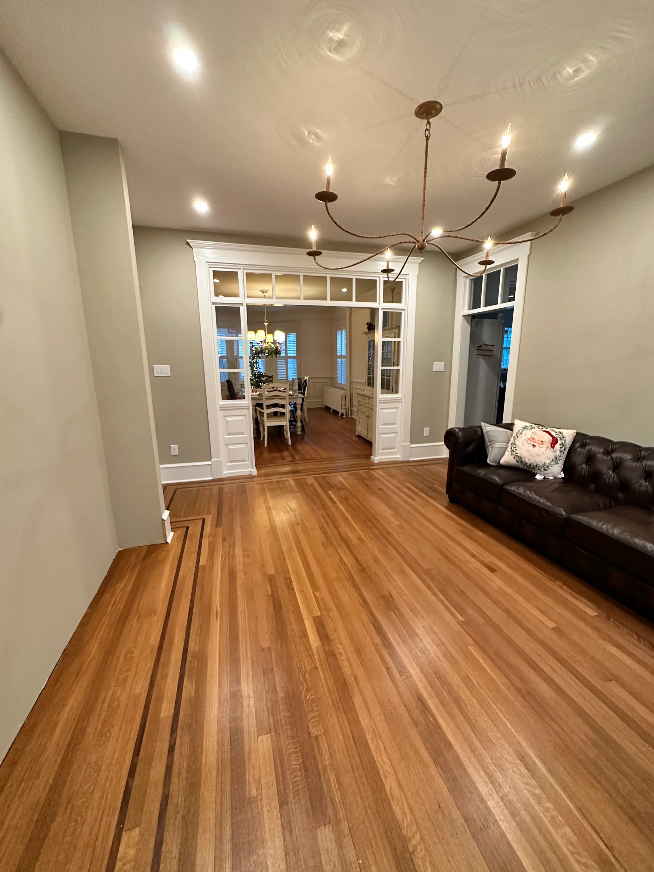 Wide hallway with wood floors leading to a dining room