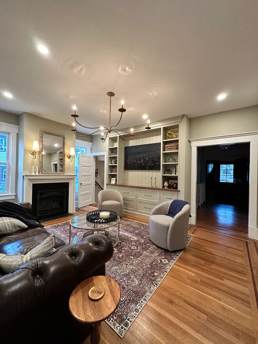 Living room with a fireplace and flanking built ins