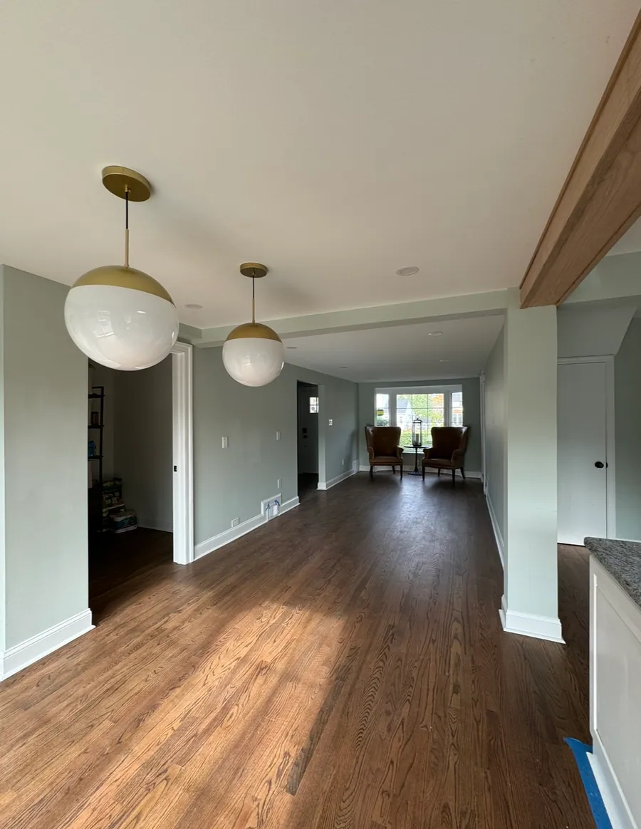 Open plan living space with pendants and wood floors