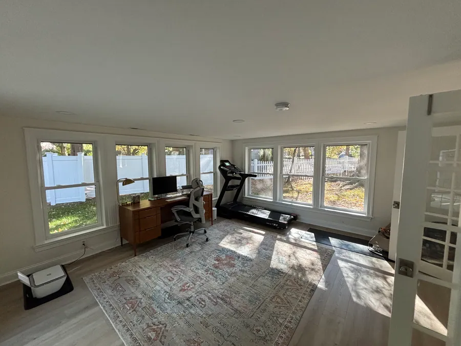 Bright sunroom addition with windows on three sides