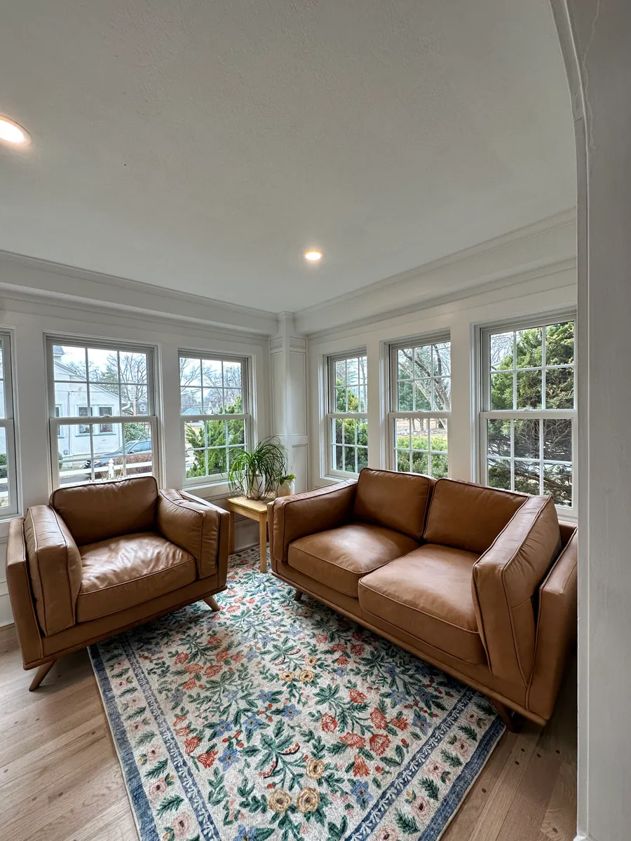 Sunroom addition with leather seating and windows