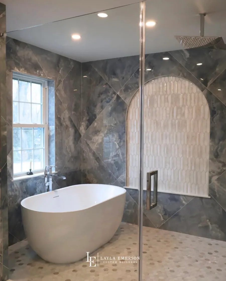 Blue marble shower next to a freestanding tub