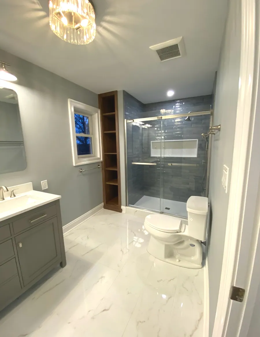 Bathroom with a grey vanity and walk in glass shower