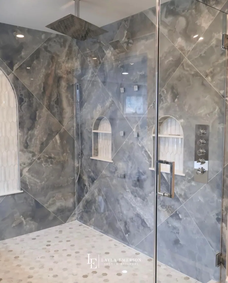 Tiled shower niche with brass fixtures