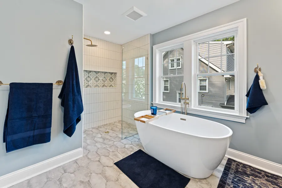 Primary bathroom with a freestanding tub beneath a window