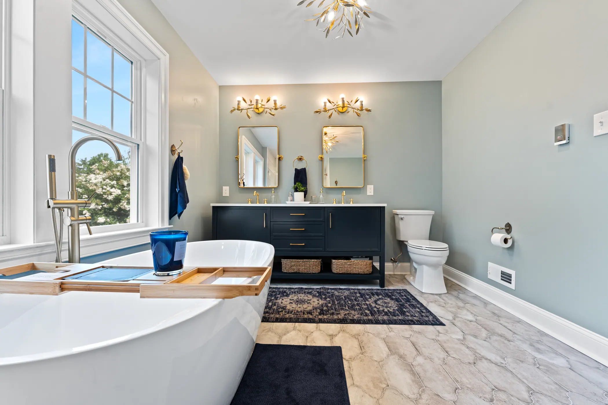 Bathroom with a tub, double vanity and tile floor