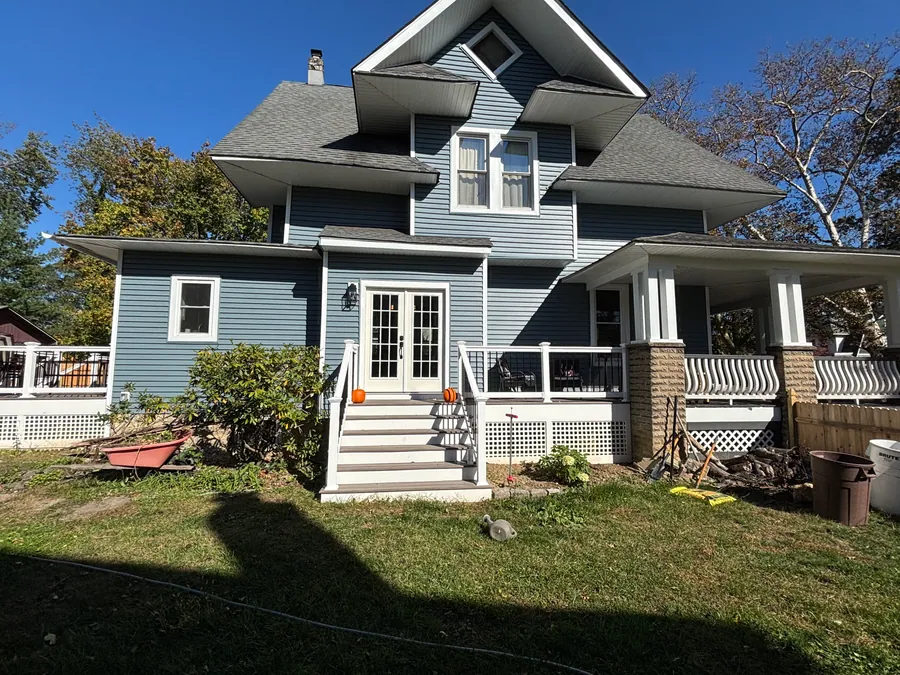 Blue victorian home with white trim