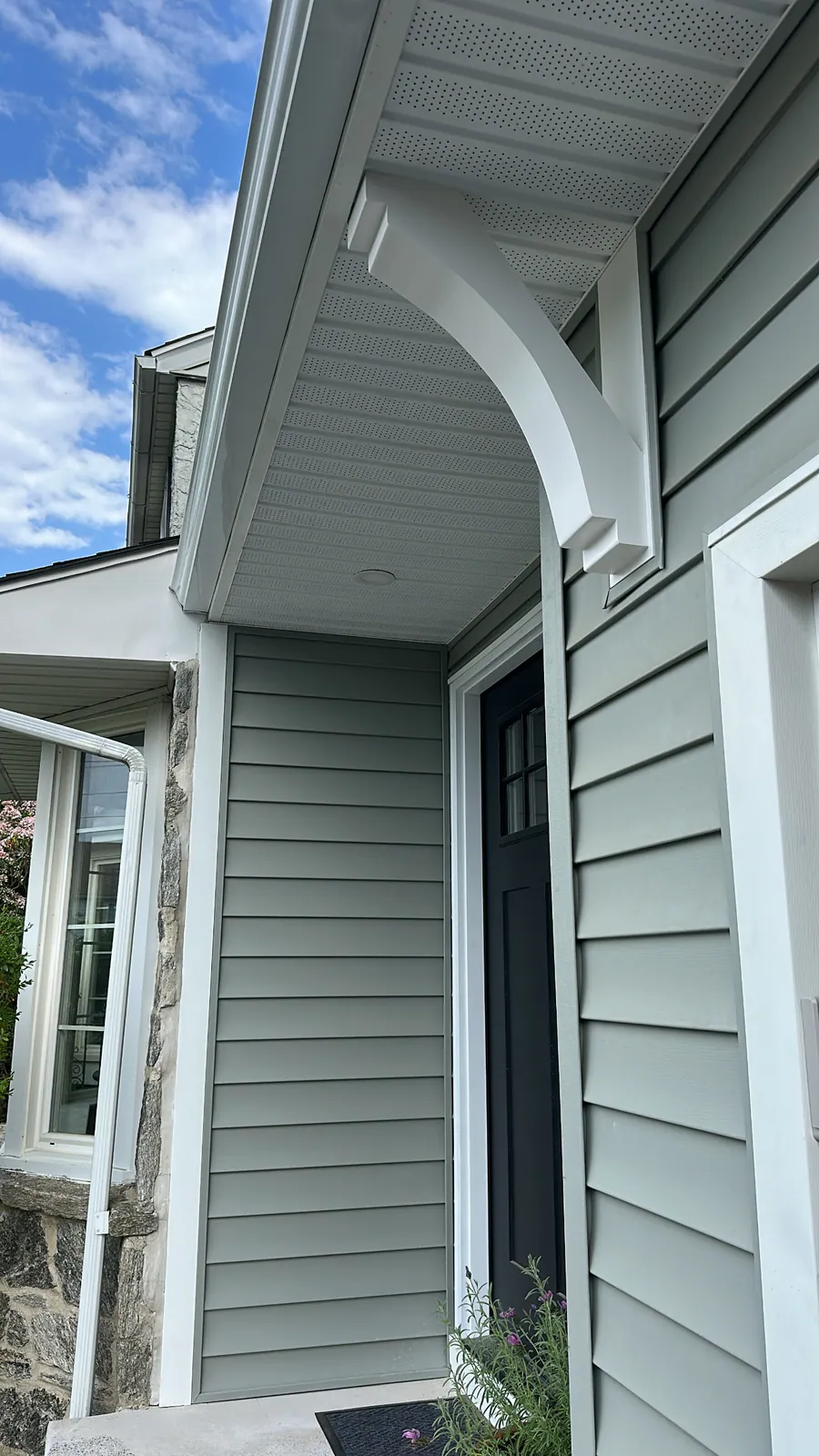 Exterior bracket detail on green siding