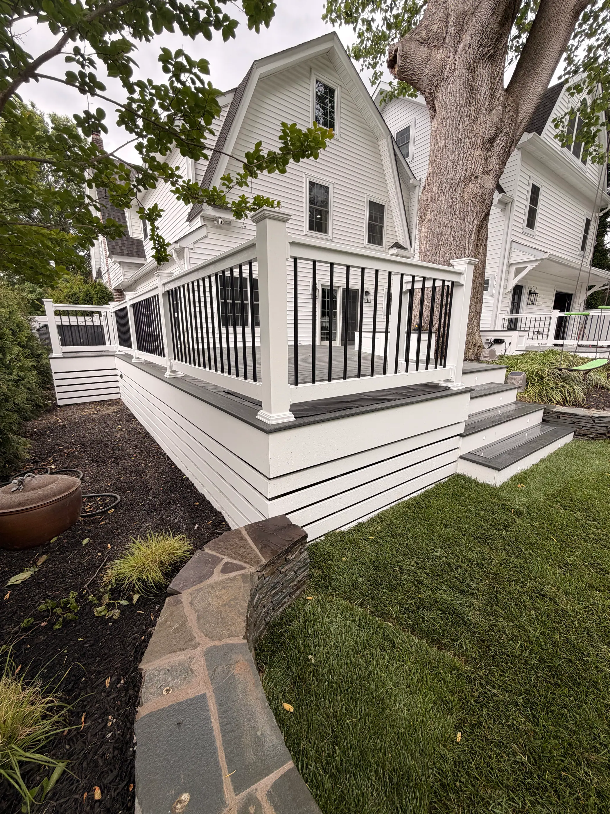 White deck along the rear of a home