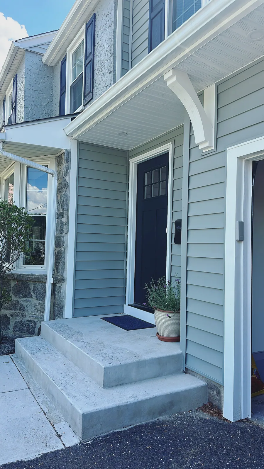 Front entry with brackets and a panelled door