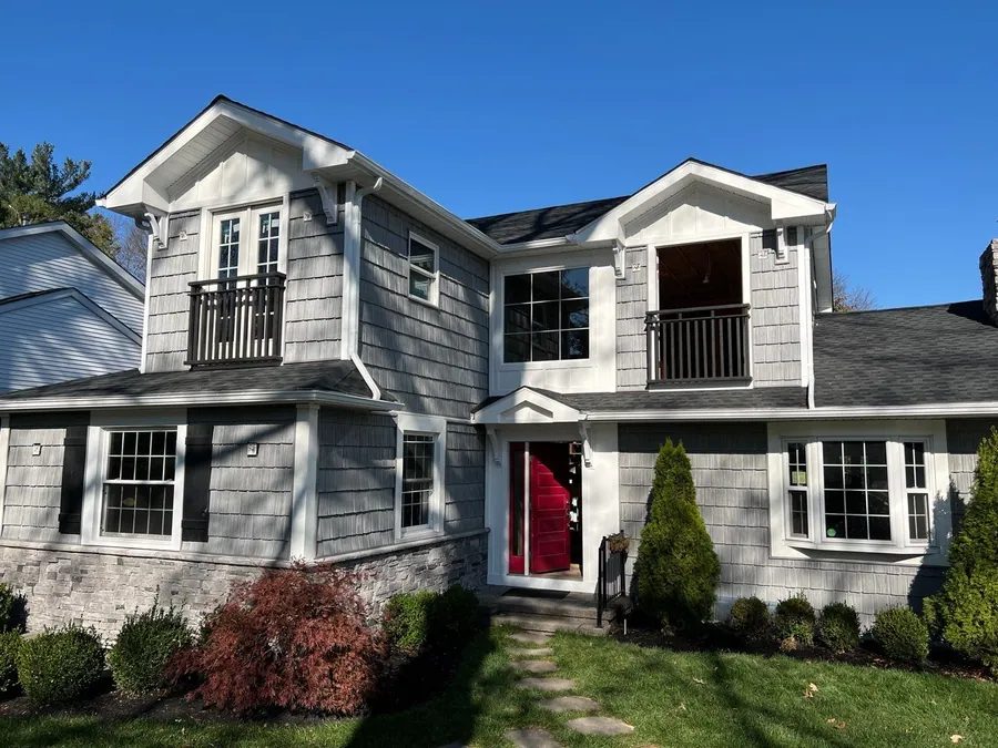 Cedar shingle home with white trim and a covered entry
