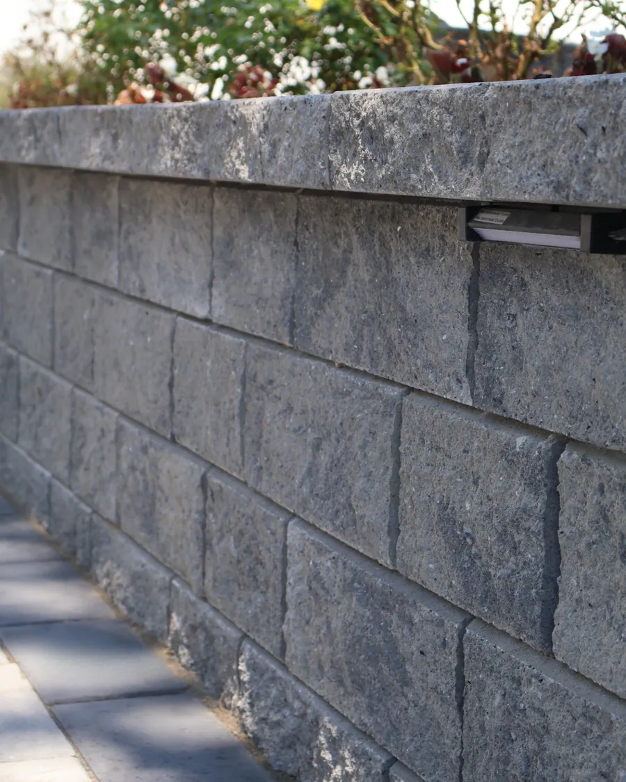 Stone retaining wall with a planted bed