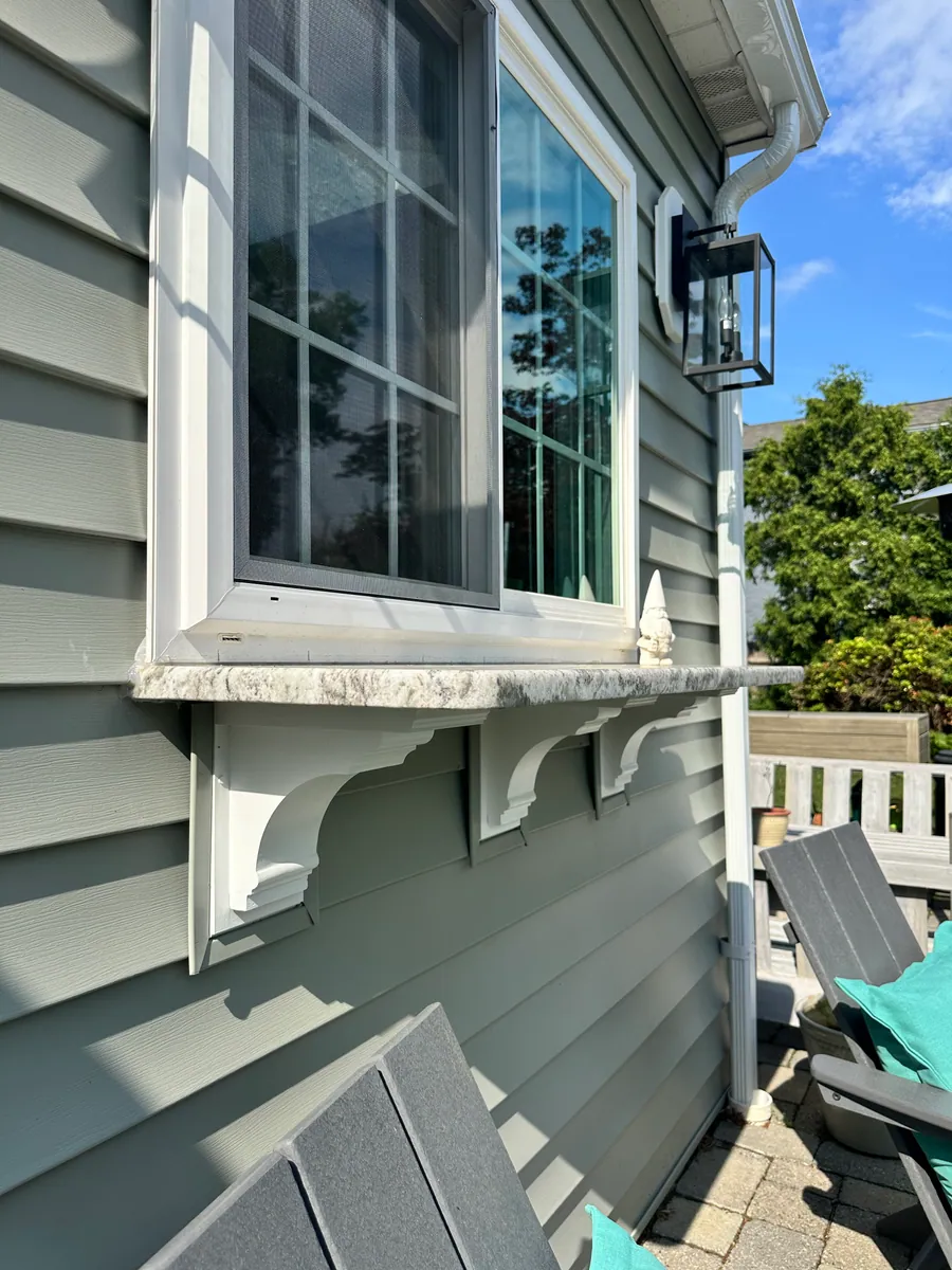 Exterior corbels supporting a window shelf