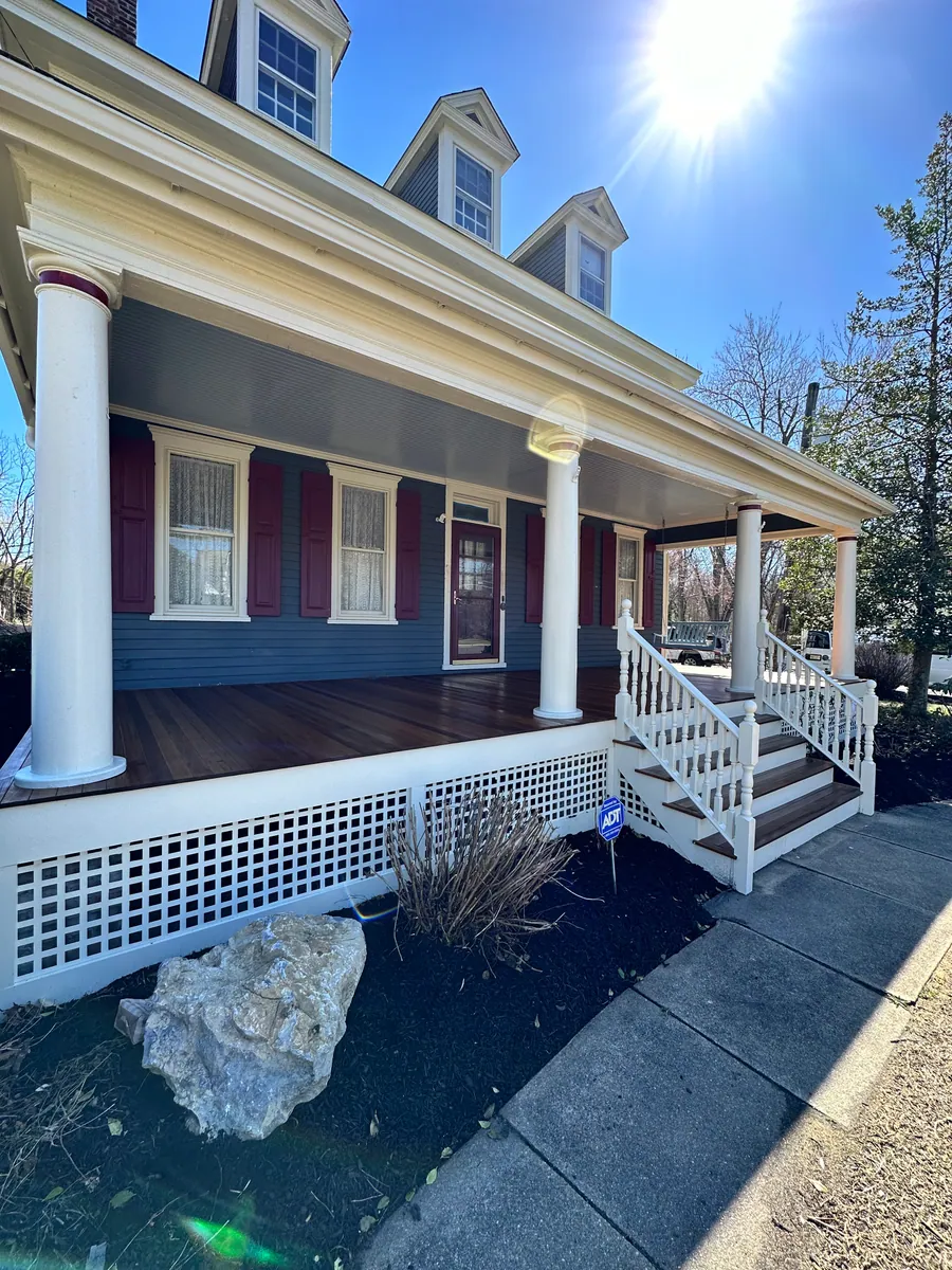 Wraparound porch with columns and mahogany decking