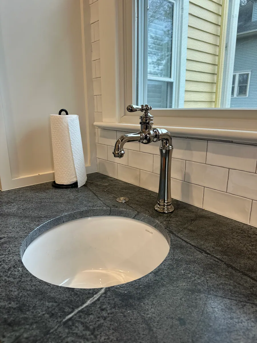 Soapstone counter with an undermount sink and bridge faucet