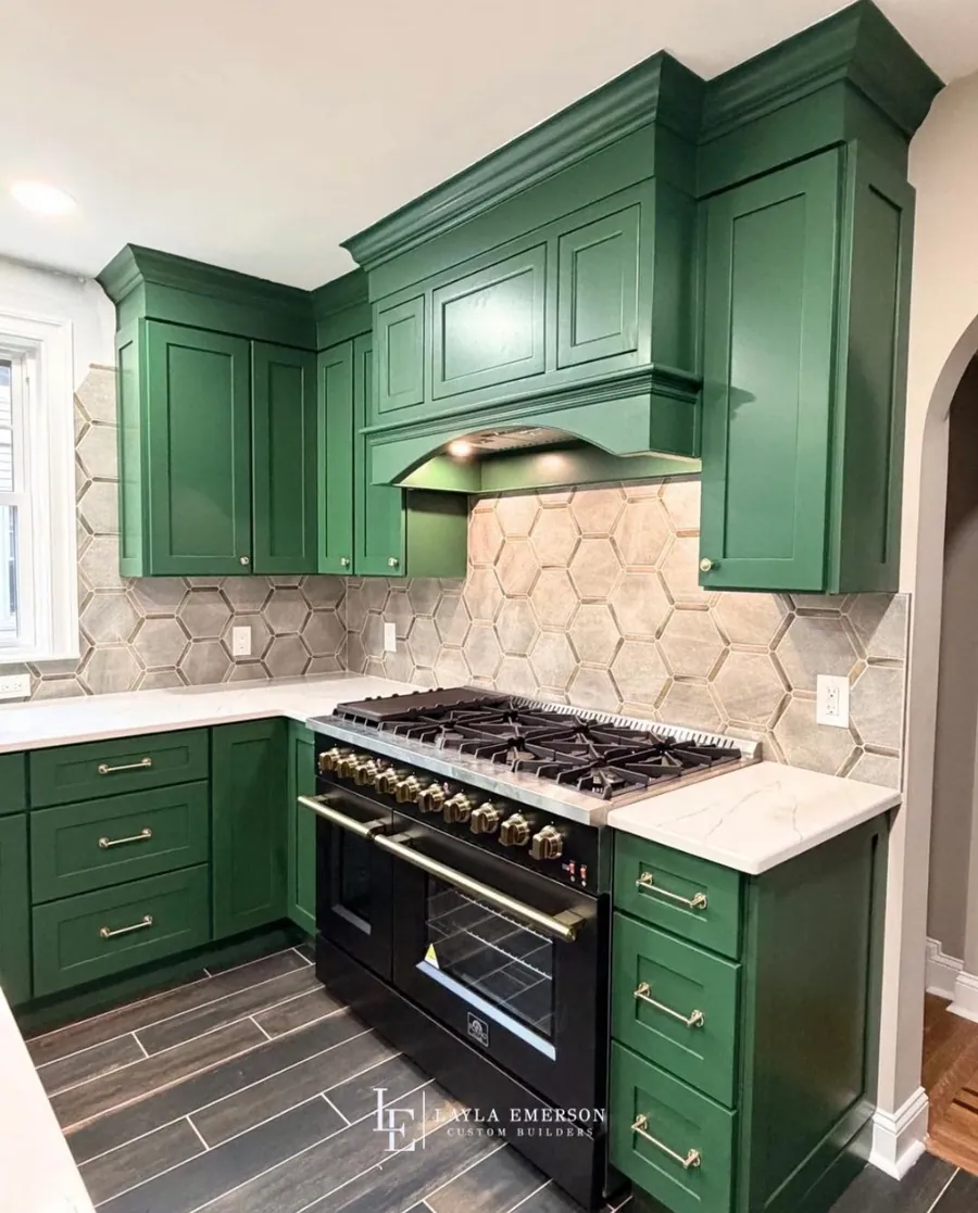 Green kitchen with a hex tile backsplash and open shelving