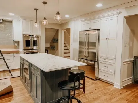 Kitchen island with marble top, stools and glass pendants