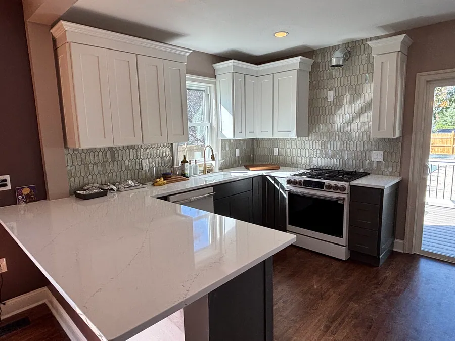 White kitchen with a peninsula and stainless appliances