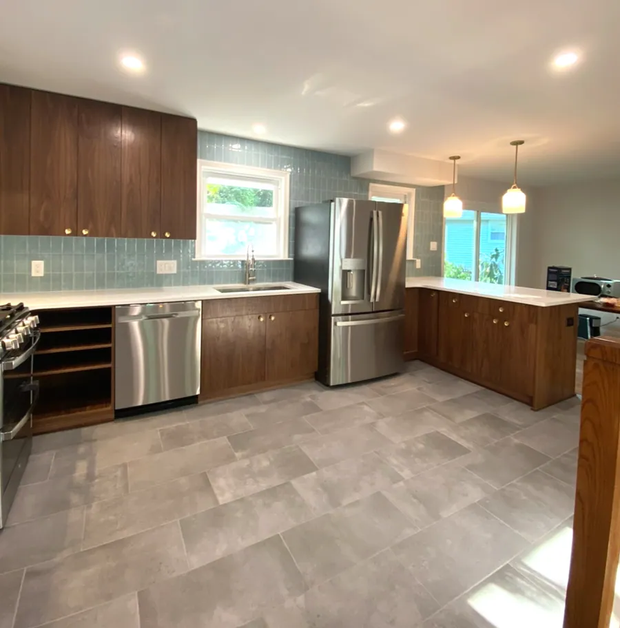 Kitchen with walnut cabinetry and a glass tile backsplash