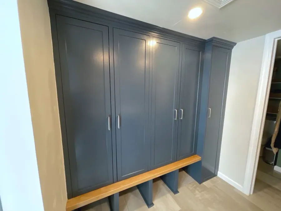 Blue mudroom lockers with a wood bench