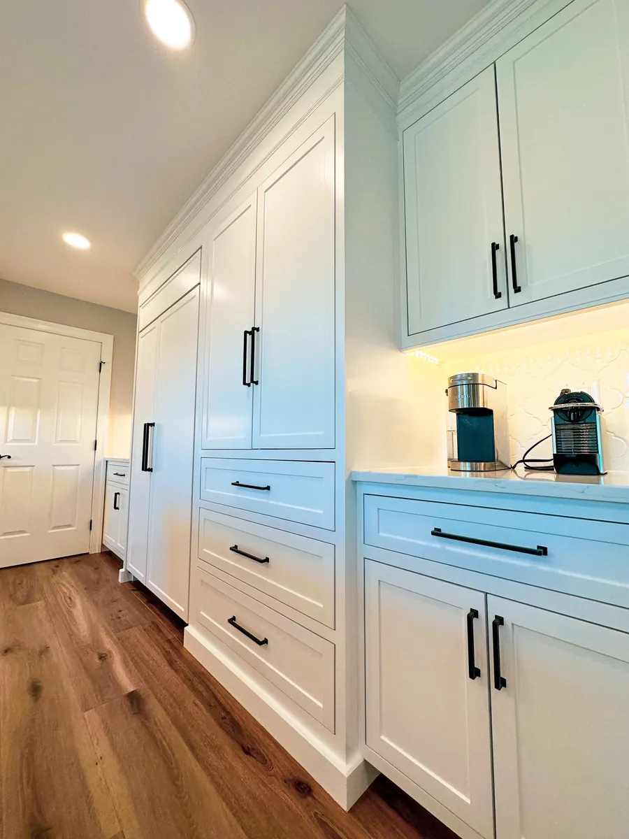 Mudroom cabinetry in white and blue with a bench