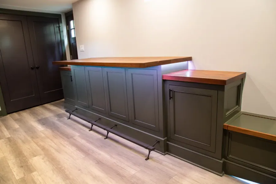 Bar cabinetry with a wood counter and cabinets below
