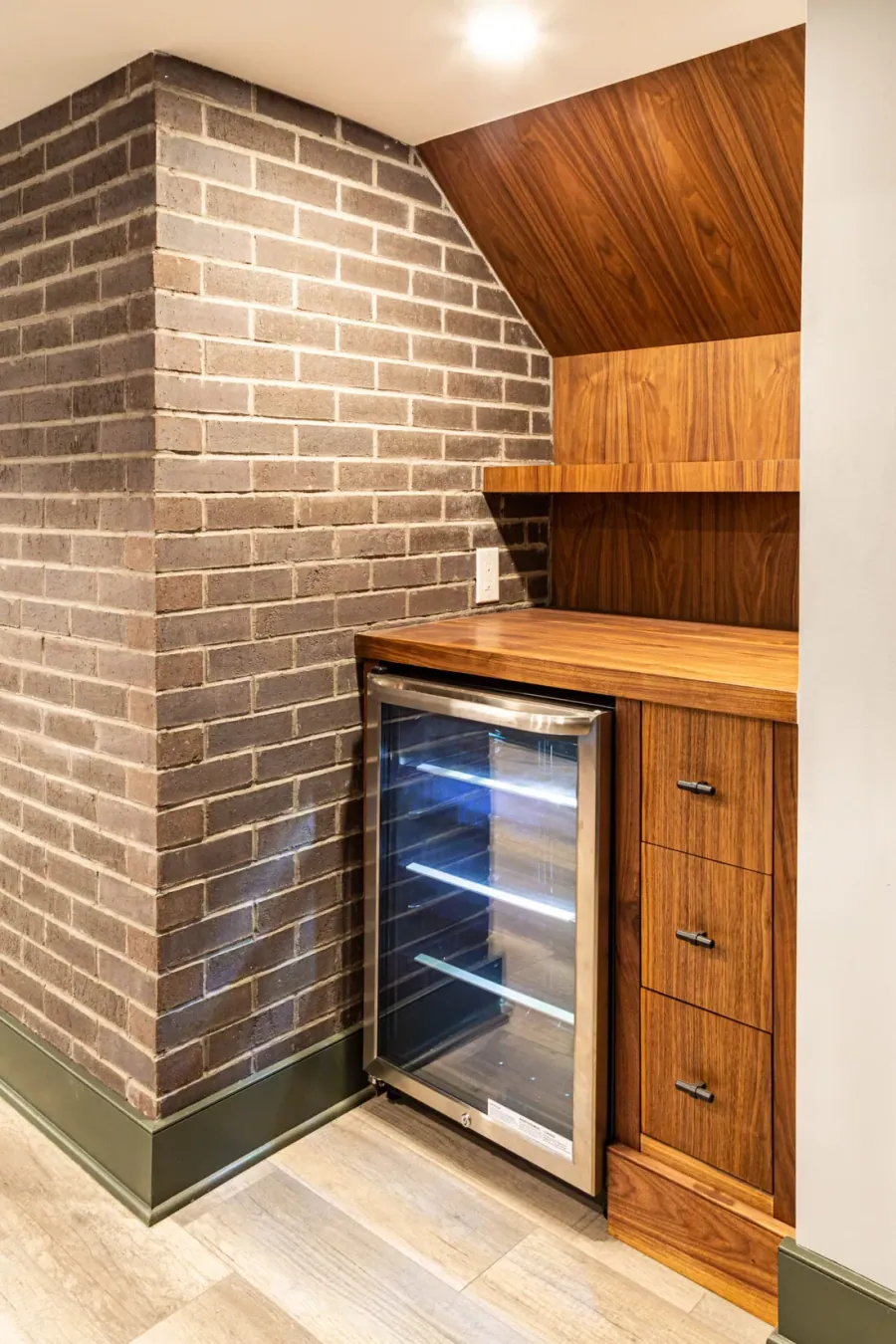 Bar with a brick surround, wood counter and wine fridge
