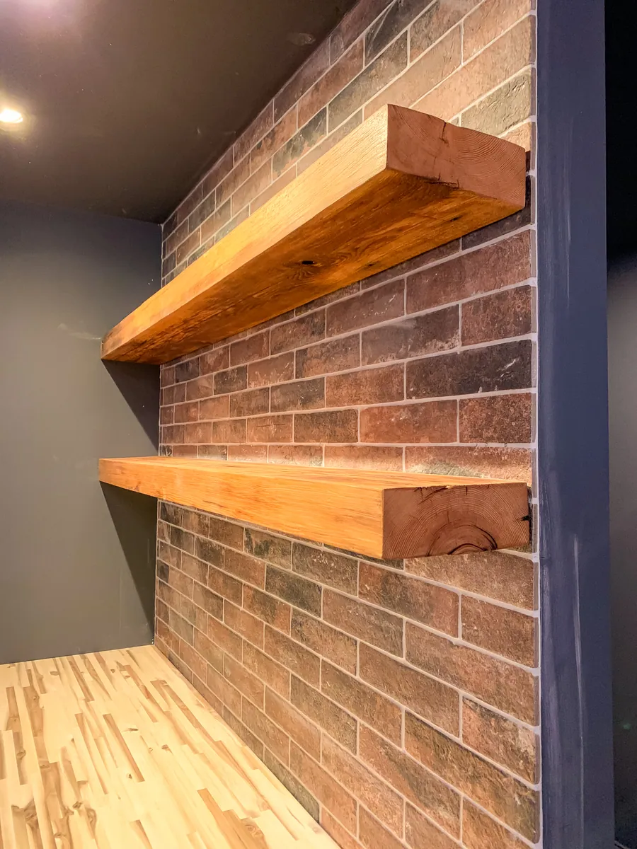 Brick fireplace with floating wood shelves