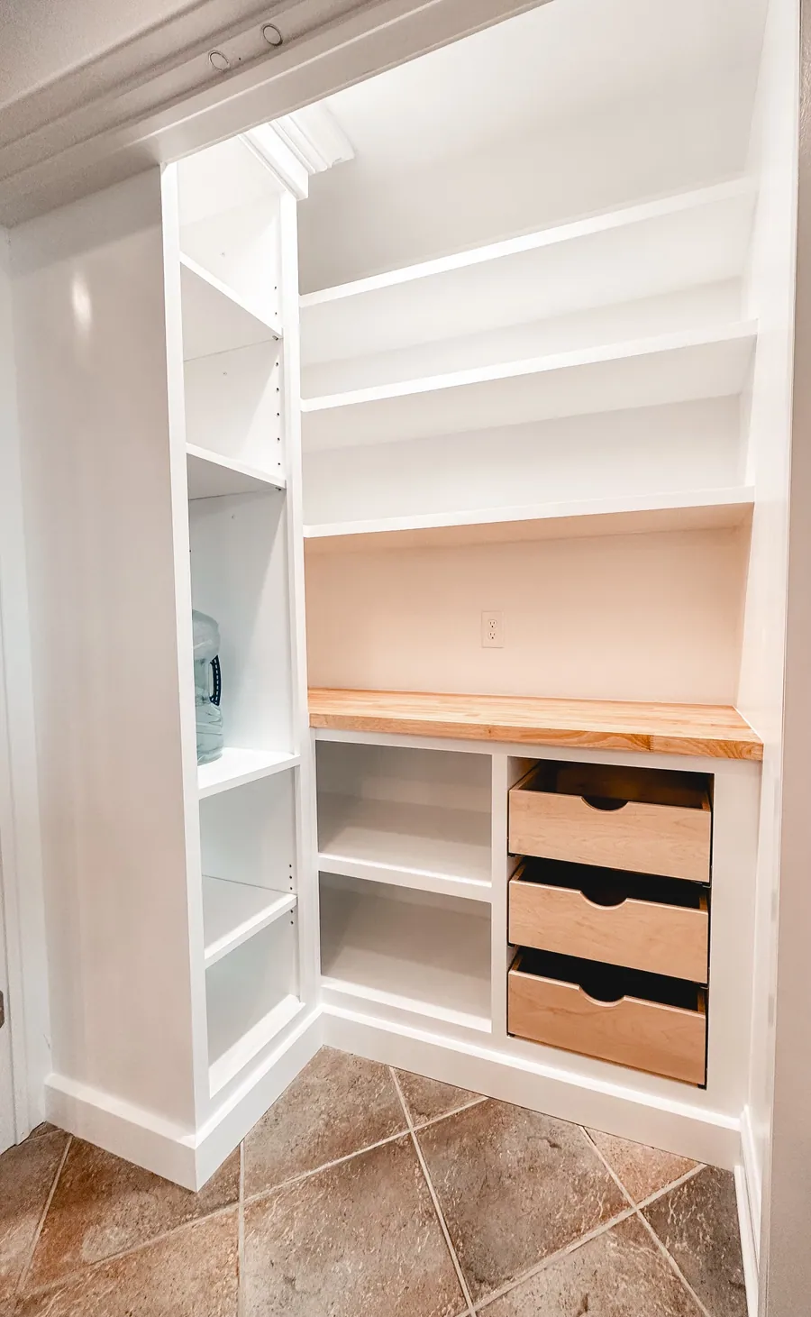Built in cabinetry with drawers and open shelving