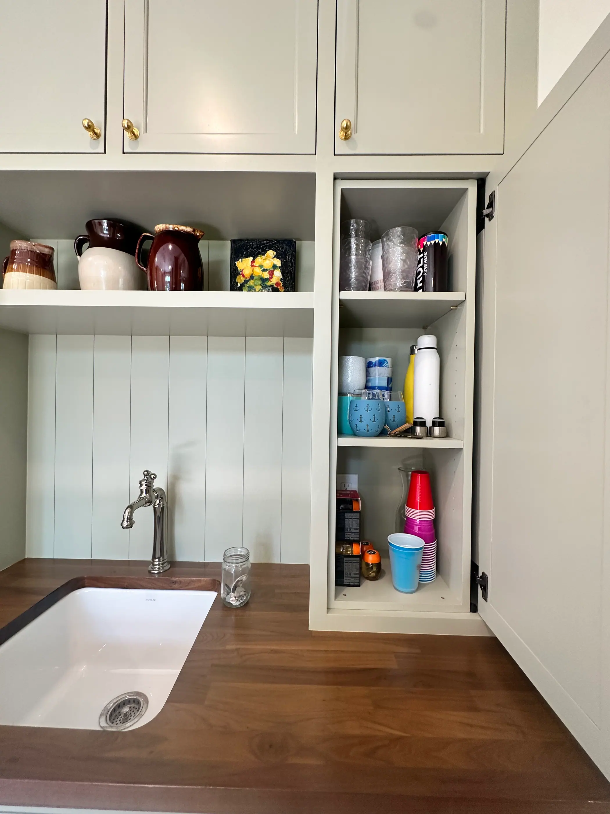 Butler pantry with a sink, shiplap and open shelves
