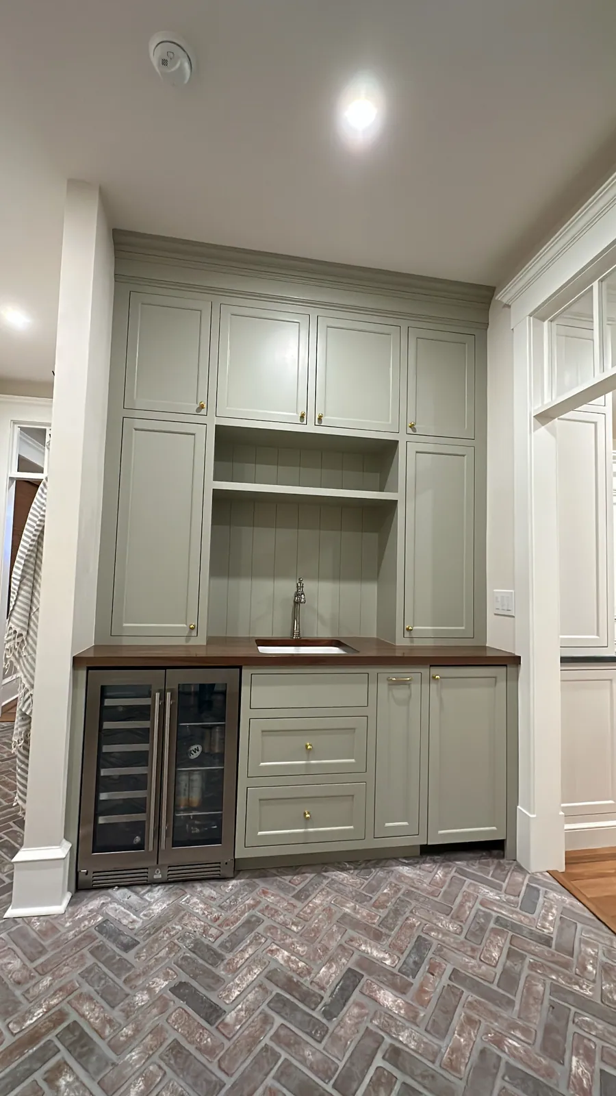 Butler pantry with a wine fridge and open shelving