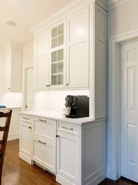 Coffee bar cabinetry with glass uppers