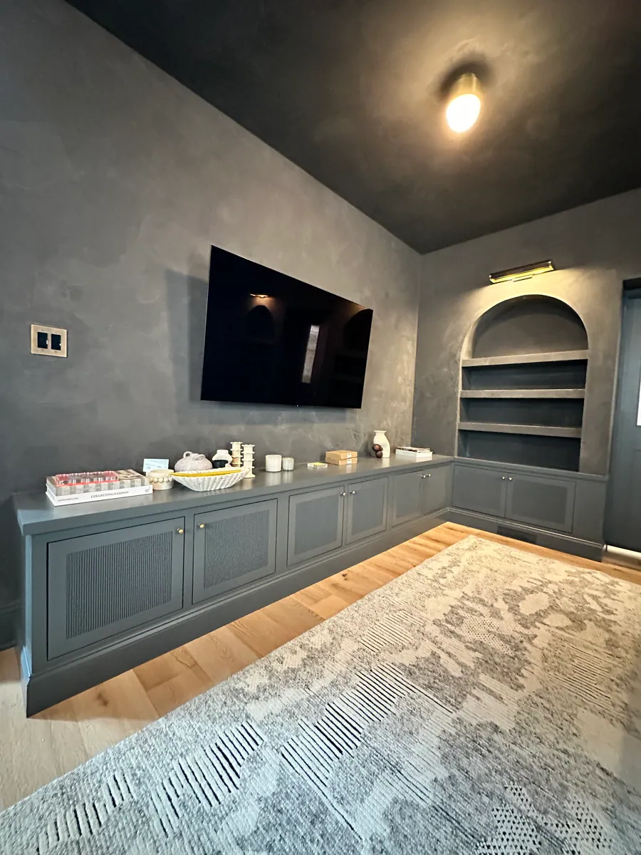 Den with a built in cabinet and television surround