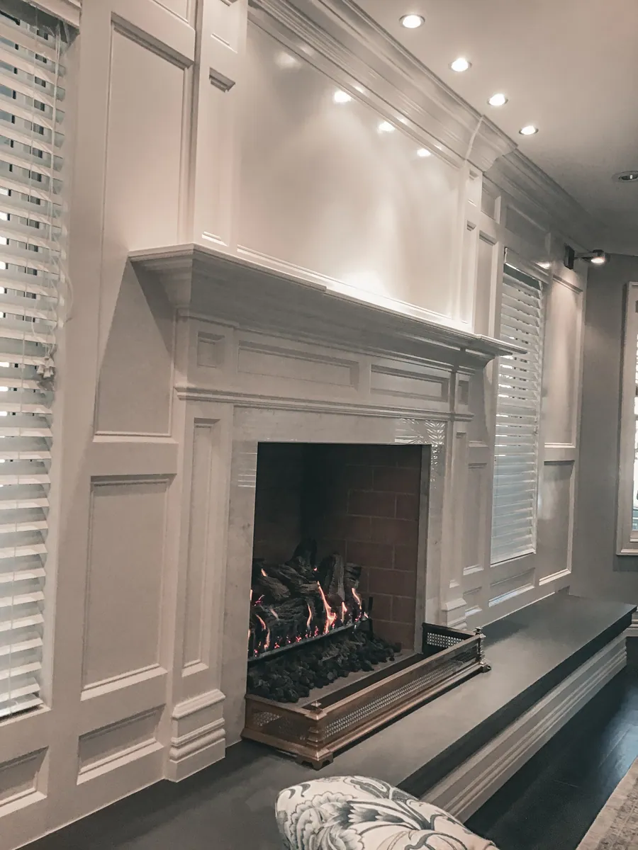 Painted fireplace mantel with fluted detail