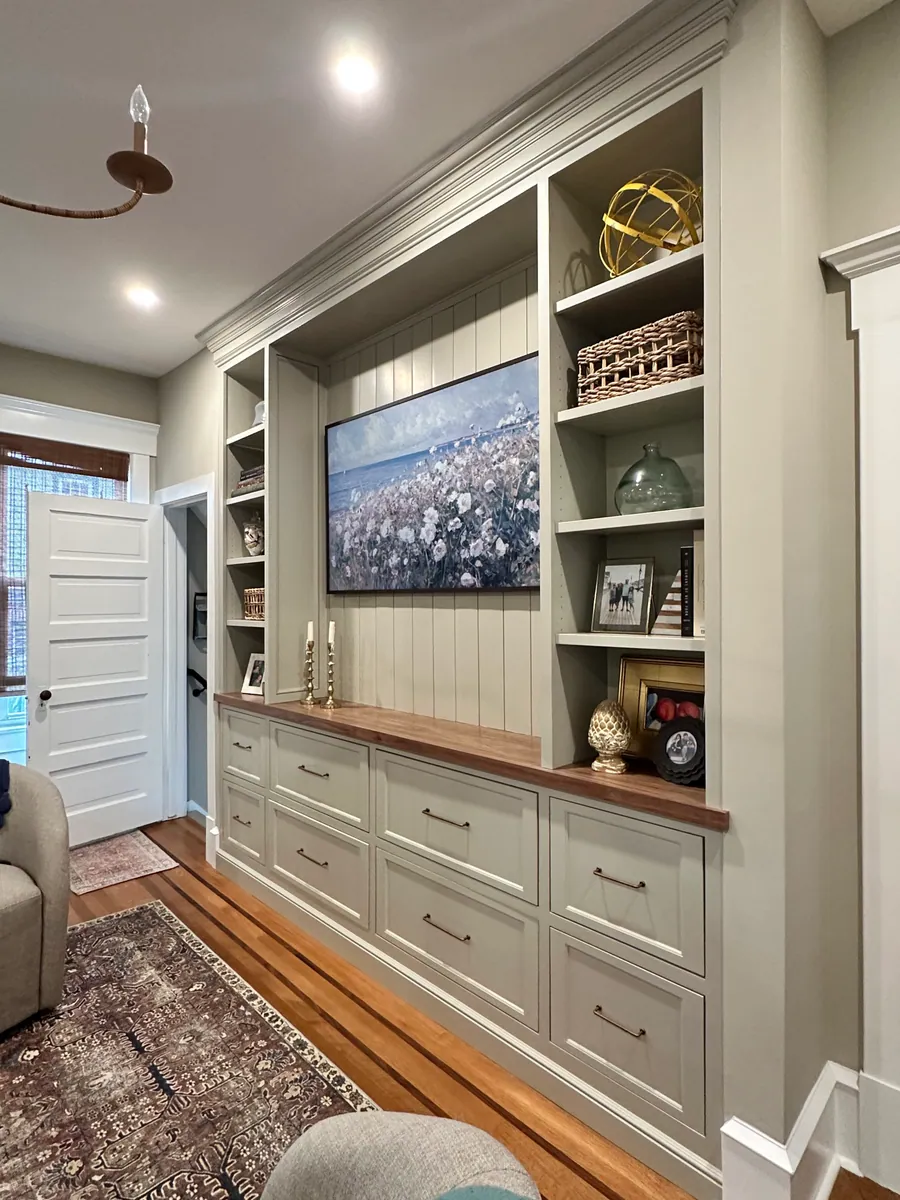 Living room built in with a wood counter and cabinets