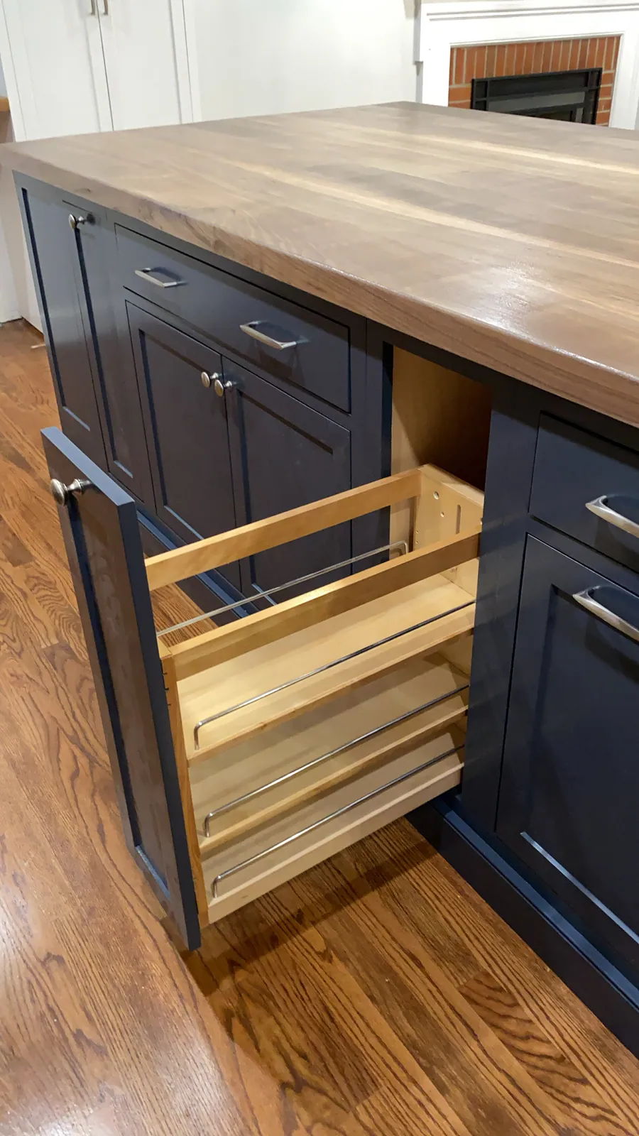 Navy cabinet pullout with a wood top