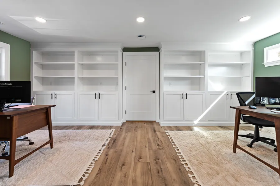 Home office with white built in cabinetry and shelving