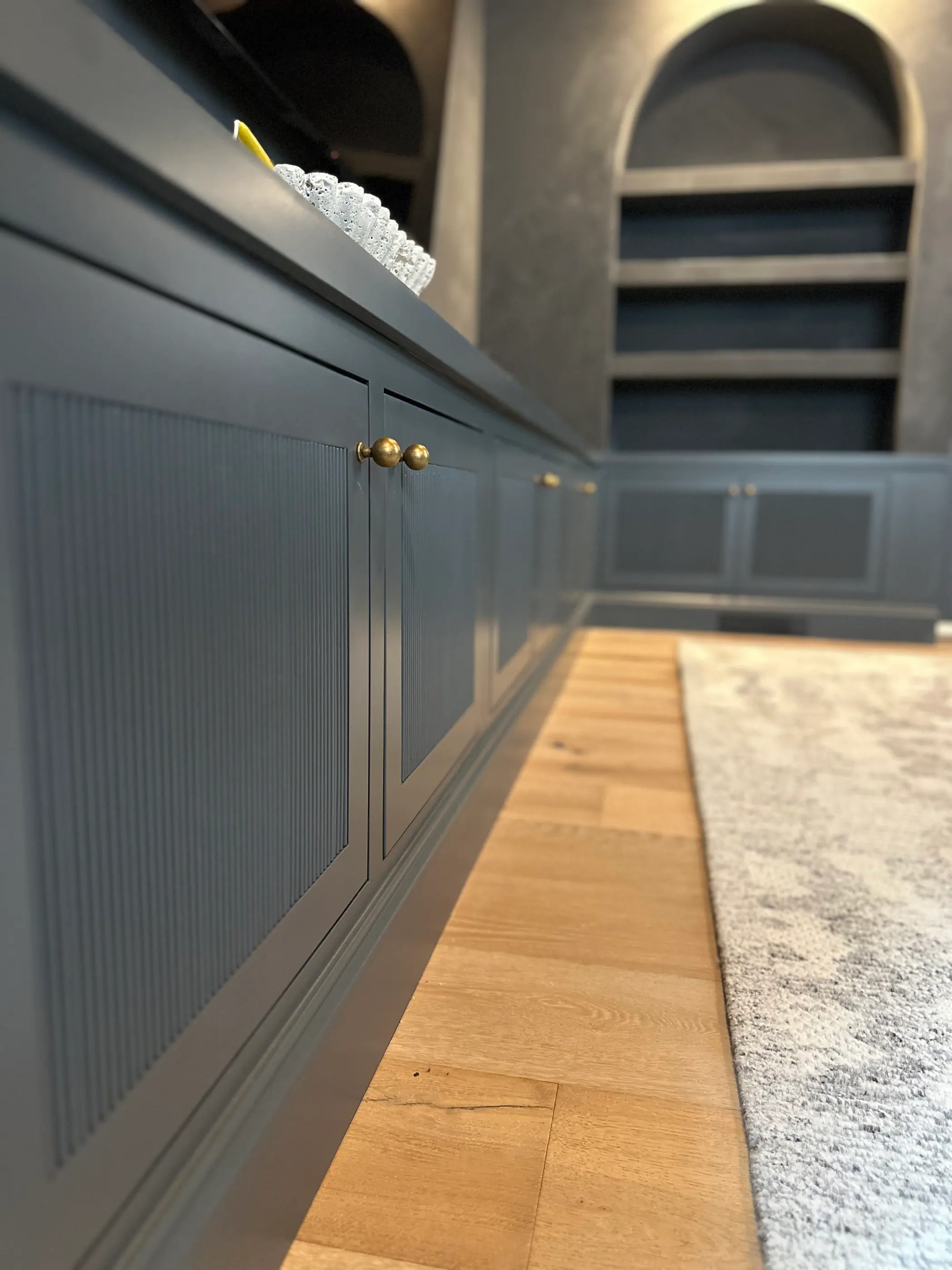 Panelled hallway with arched display niches