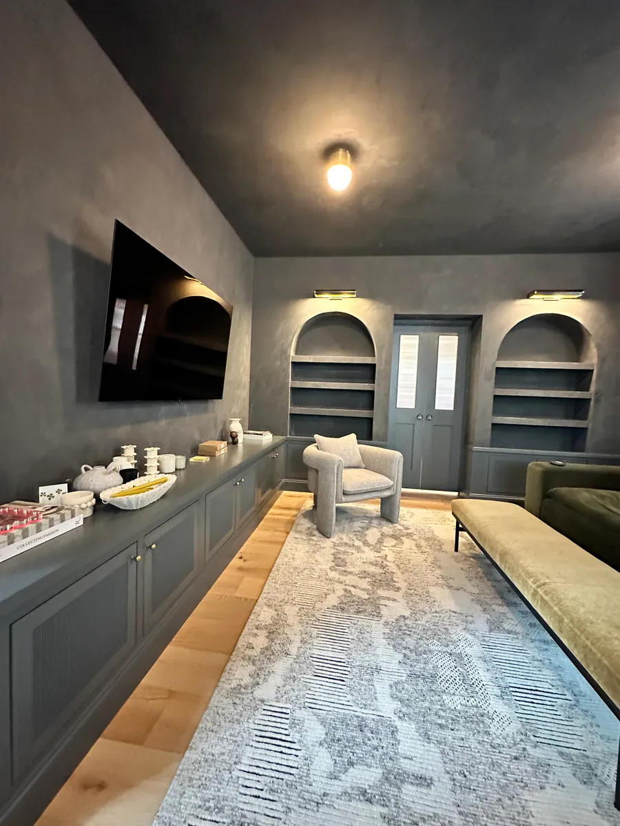 Den with plaster ceiling, arched niches and built in cabinets