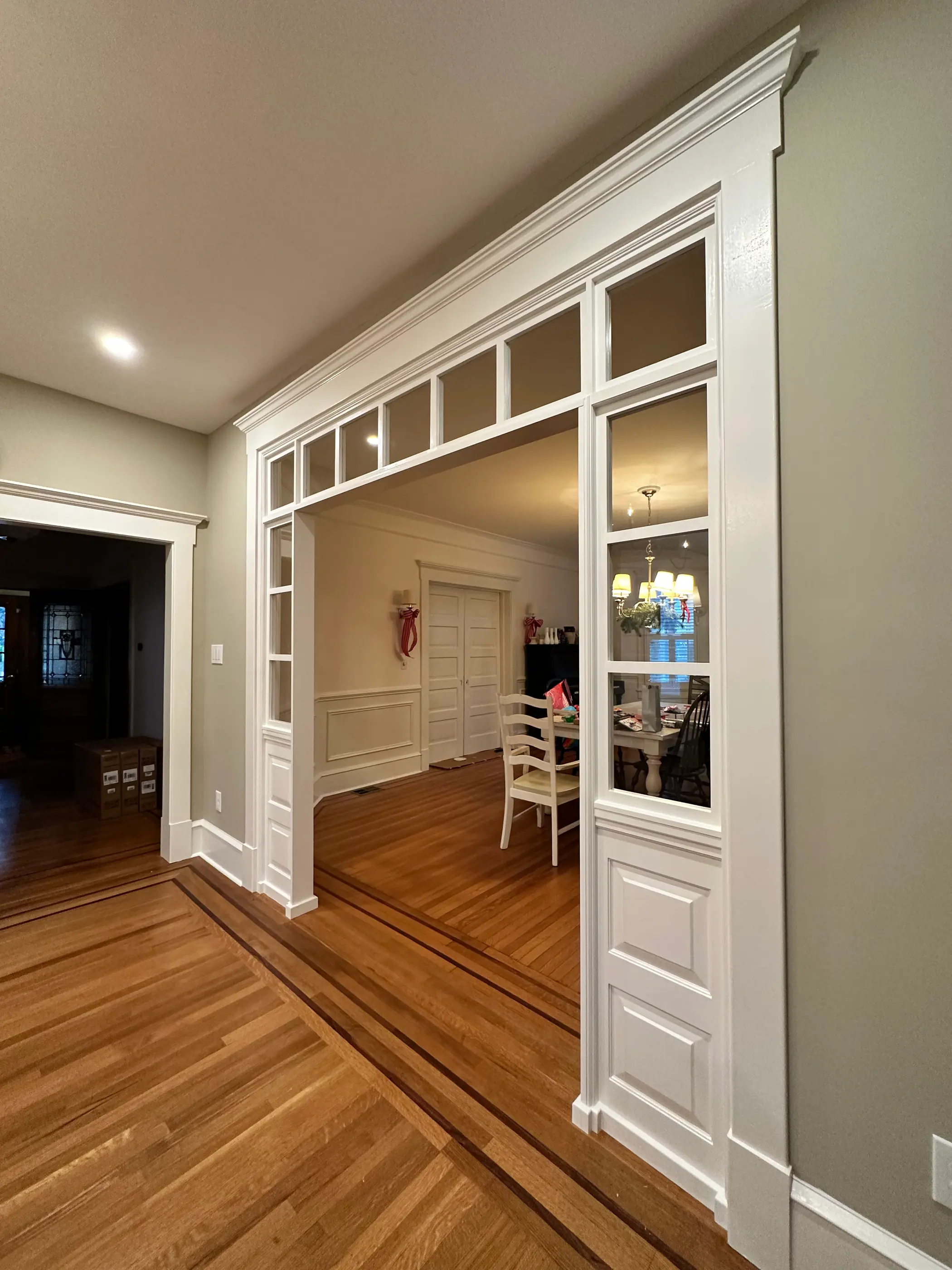 Interior partition with transom windows and panelled trim