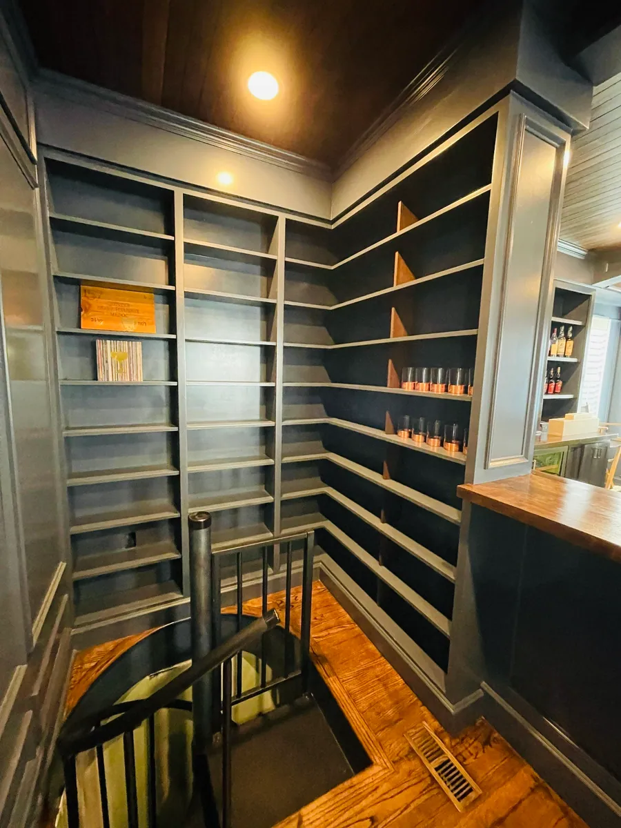 Wine room with dark stained shelving