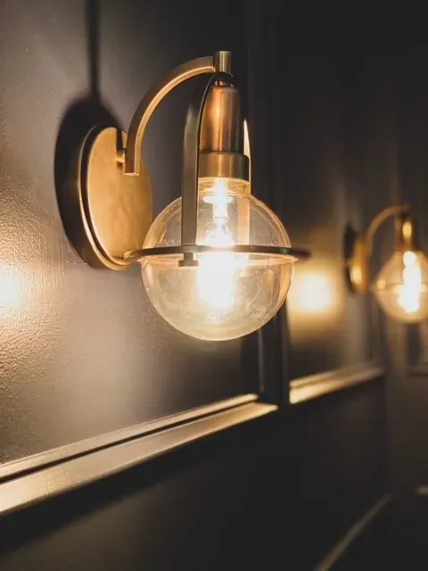 Brass sconce mounted on a finished wall