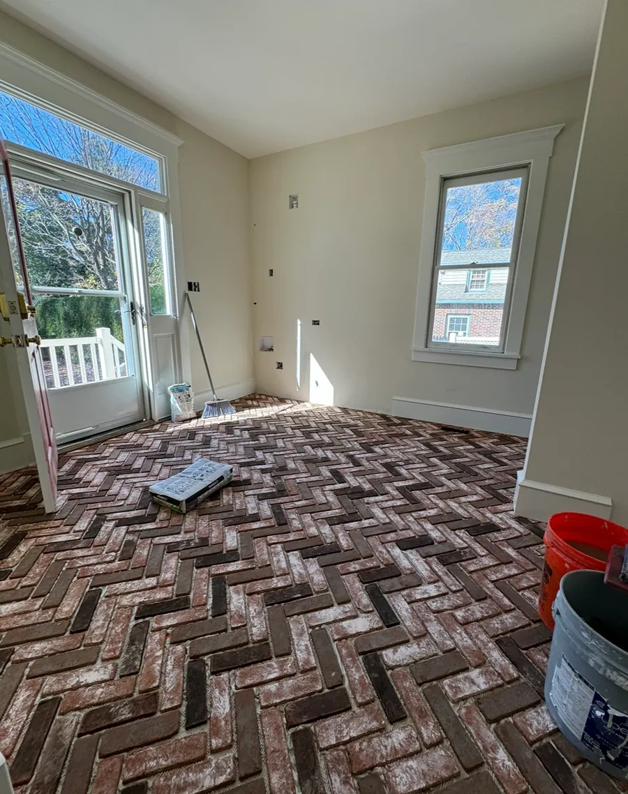Brick herringbone floor being set