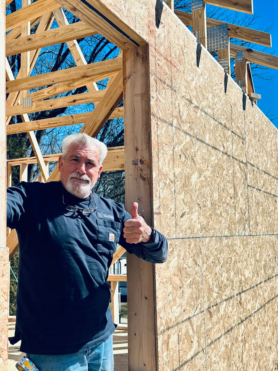Craftsman holding a sheathing panel