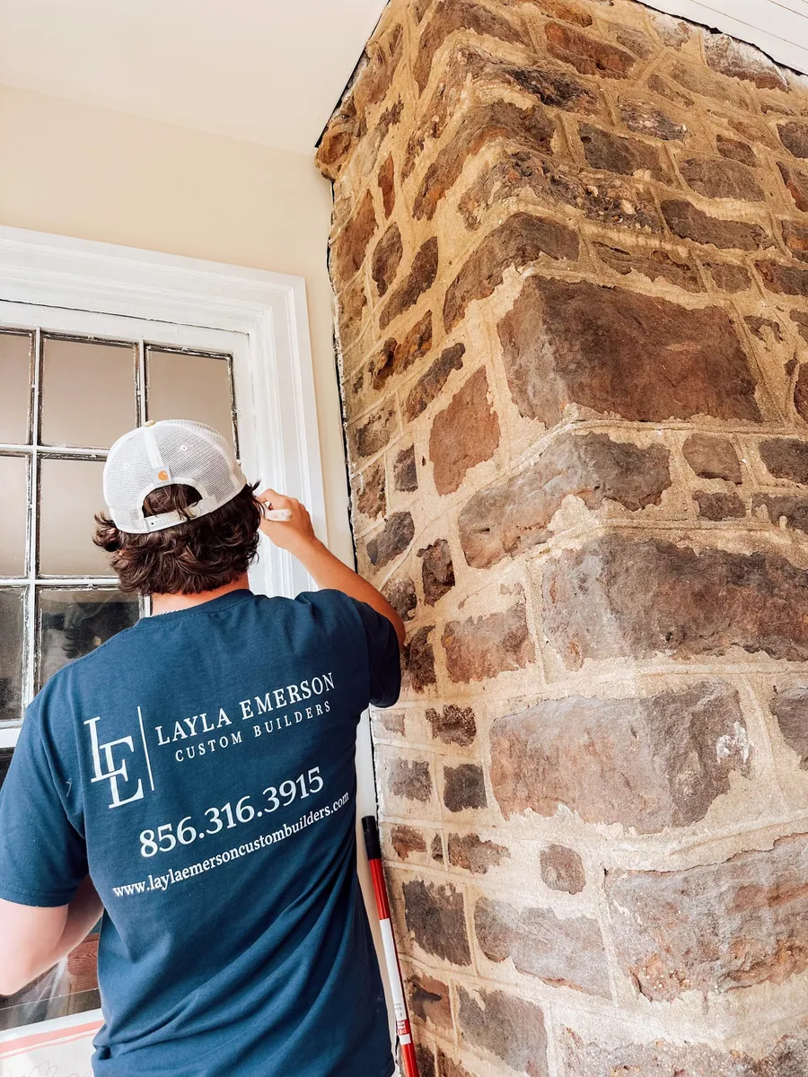 Crew working on a stone chimney