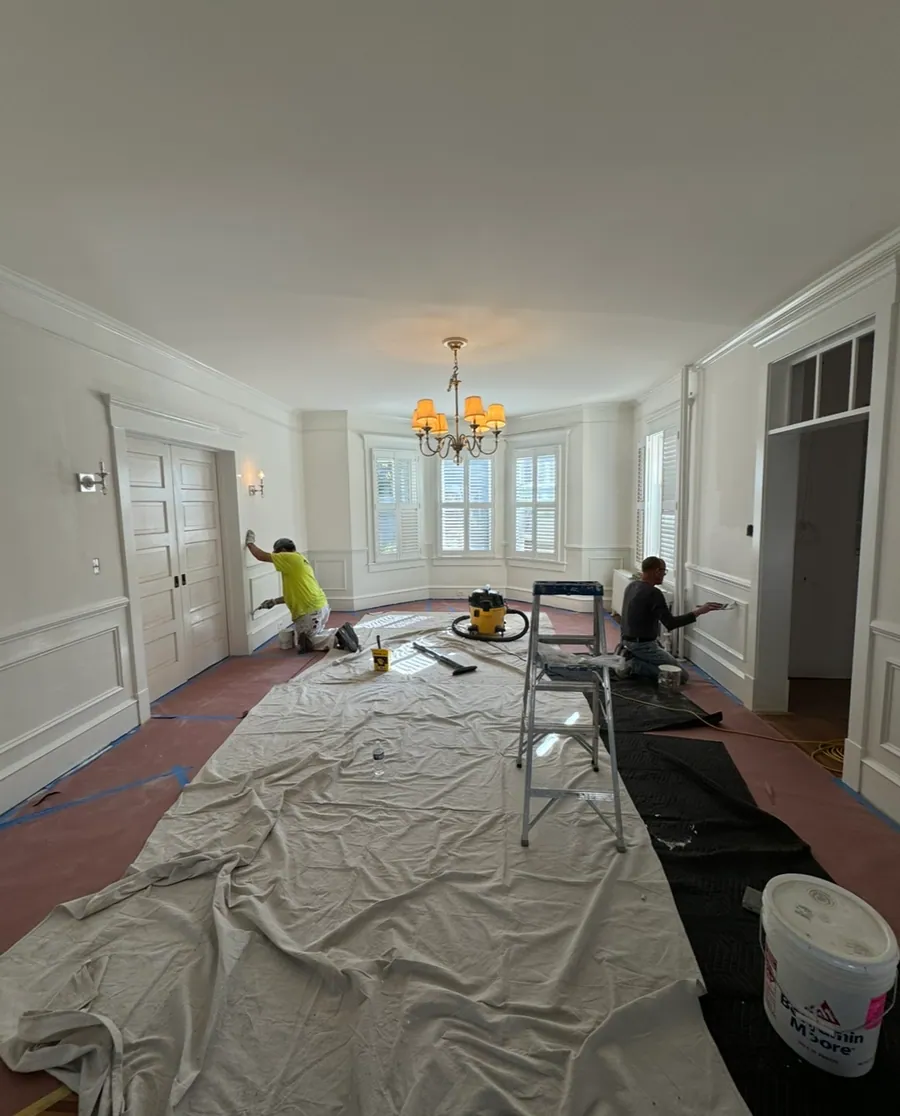 Crew painting a room before trim goes in