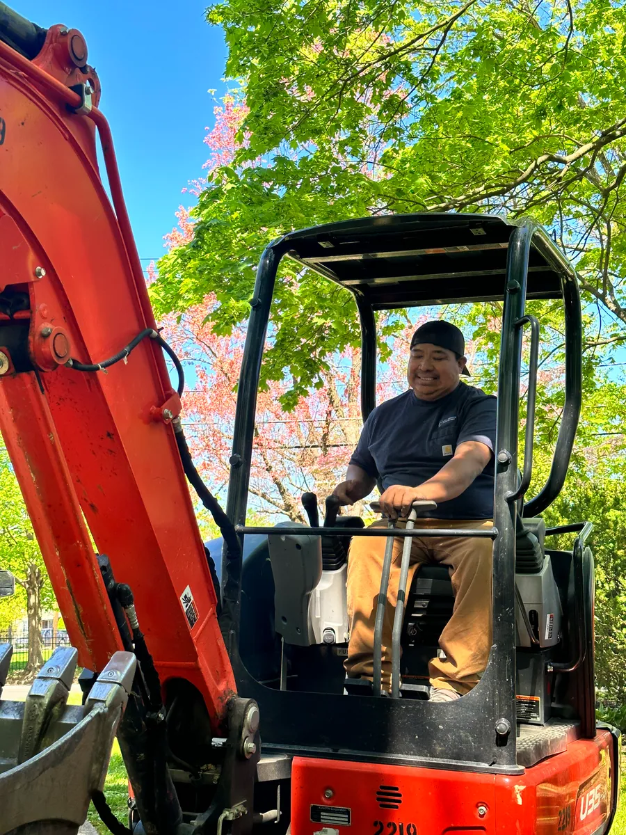Operator running a compact excavator